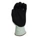 A close-up of an Armor Guys green A4 HDPE glove with black HCT microfoam nitrile coating.