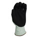 A close-up of a green Armor Guys Basetek HDPE glove with black HCT nitrile coating.