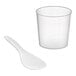 A clear plastic measuring cup and white plastic spoon.