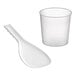 A clear plastic measuring cup and white plastic spoon.