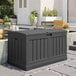 A grey Suncast resin outdoor storage box on a patio.