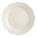 An Acopa ivory stoneware plate with a scalloped edge.