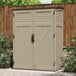 A tan Suncast outdoor storage shed with a door.