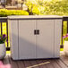 A white Suncast outdoor storage cabinet on a deck.