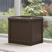 A Suncast brown plastic outdoor storage box on a white tile floor.