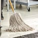 A natural cotton Cut-End Mop head on a floor.