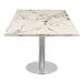 A white calacatta sintered stone table top with a metal pole base.