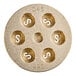 A circular brass Casarecce pasta die with holes in it.