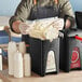 A man using a ServSense plastic pouch dispenser to fill a container.