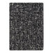 A close-up of the black and white grid pattern on a Joy Carpets Onyx area rug.