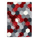 A red rug with grey and white hexagons in a room.