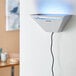 A white Lavex Zap N Trap wall sconce with blue light on.