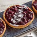 Three small berry tarts in a Pavoni Formasil round silicone mold.