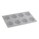 A white silicone mold with leaf-shaped patterns in it.