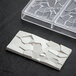 A white rectangular polycarbonate chocolate bar mold with cracks.