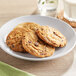 A Pavoni silicone baking mat with chocolate chip cookies on a plate.