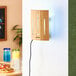 A wooden rectangular Lavex Zap N Trap wall sconce with a blue and white light and cord attached to it.