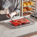 A person using a Pavoni round silicone baking mold to make chocolate truffles.