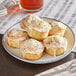 Lemon poppy seed muffins on a white plate.