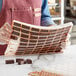 A woman holding a Pavoni Chocoflex silicone chocolate bar mold filled with chocolate bars.