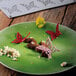 A brown and white butterfly shaped Pavoni Gourmand silicone baking mold with white flowers on it.