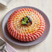 A pink cake baked in a Pavoni Pavocake Facon baking mold with blueberries on top.