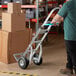 A man pushing a Lavex aluminum hand truck.