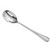 An Acopa stainless steel slotted serving spoon with a Swirl pattern on the handle.