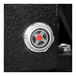 The red button on a black metal door of an Industrial Air portable air compressor.