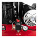 A red Powermate stationary air compressor with a gauge.