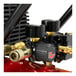 A close up of a red ProForce air compressor with black accents and brass valves.