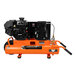 An orange and black Industrial Air Contractor portable air compressor with a hose.