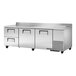 A True worktop refrigerator with two doors and two drawers on a stainless steel counter.