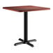 A Lancaster Table & Seating square table with a red mahogany top and a black base.