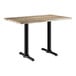 A Lancaster Table & Seating rectangular table with a barnwood finish and black metal legs.