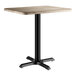 A rectangular standard height table with a gray wood finish top and a black pedestal base.