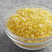 A bowl of White Toque granulated lemon zest on a table.