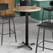 A Lancaster Table & Seating bar table with a gray wood top.