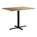 A Lancaster Table & Seating rectangular table with a gray wood finish and a black base.