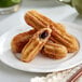 White Toque chocolate hazelnut filled churros on a plate.