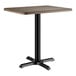 A Lancaster Table & Seating rectangular table with a dark walnut top and black base.