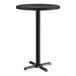 A Lancaster Table & Seating round table with a black metal base.