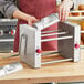 A person using the Estella manual turnover machine on a table.