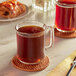 A glass mug of brown liquid on a table with two Green Mountain Coffee Roasters Colombian Select Single Serve Keurig K-Cup Pods.