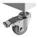 A Lancaster Table & Seating fillable umbrella base with a gray metal wheel.