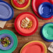 A blue Acopa Foundations wide rim melamine platter on a table with food.