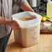 A man holding a Cambro FreshPro square container of food.