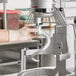 A person using a Main Street Equipment dough hook in a mixer.