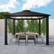 A table and chairs under a Paragon Outdoor Santa Monica aluminum gazebo.