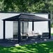 A black Paragon Outdoor Santa Monica hard top gazebo on a patio with a white couch.